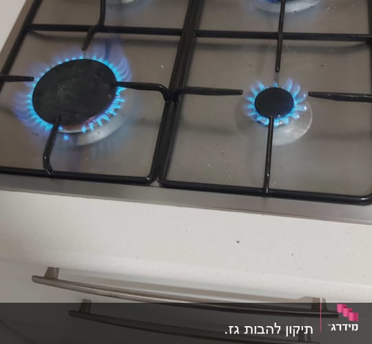 כיריים גז עם ארבעה מבערים דולקים